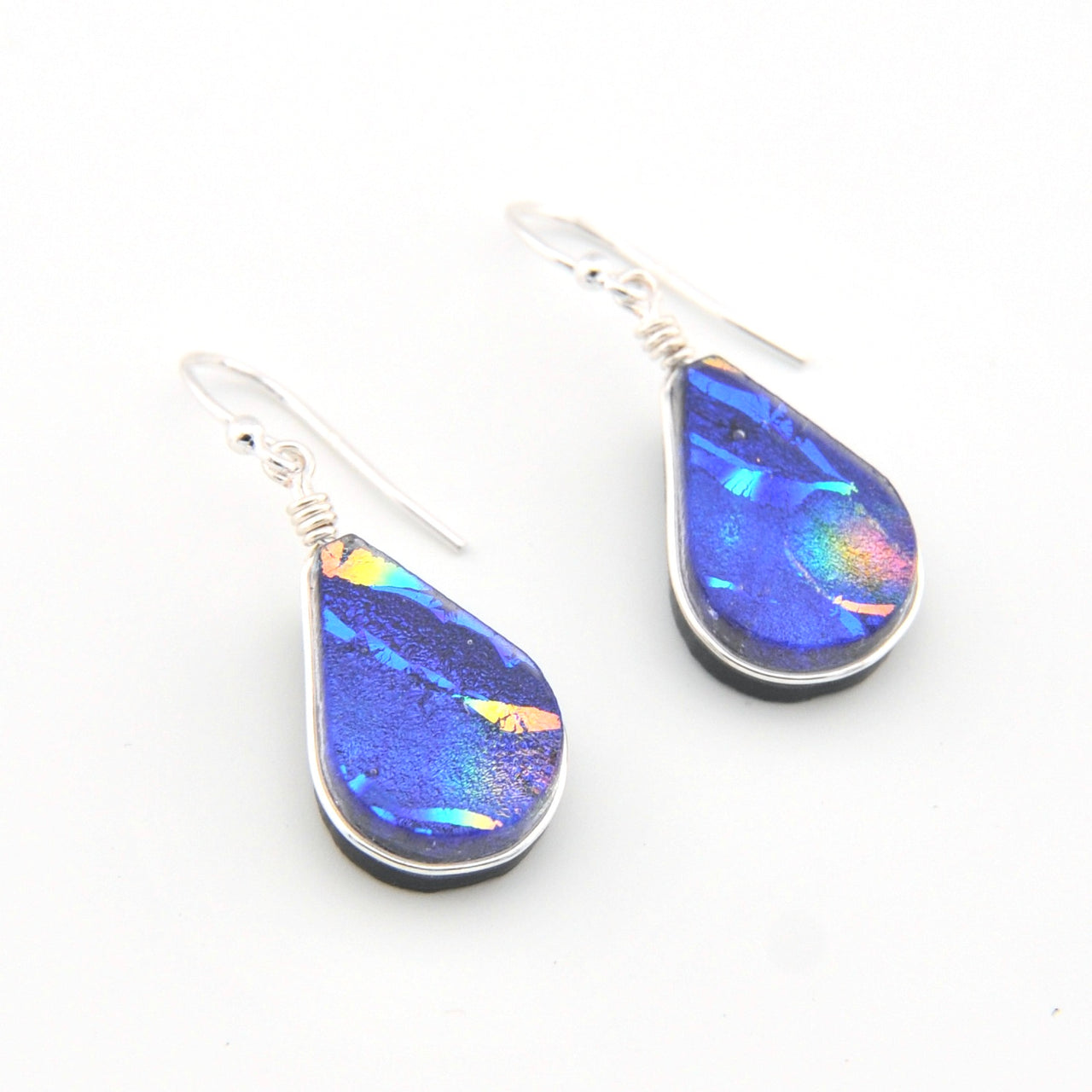 Teardrop-shaped earrings with blue and purple iridescent finish on a white background