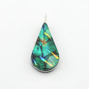 A teardrop-shaped pendant featuring a green iridescent stone with blue, yellow, and orange flashes, set in a silver bezel with a silver wire-wrapped bail, shown on a plain white background.