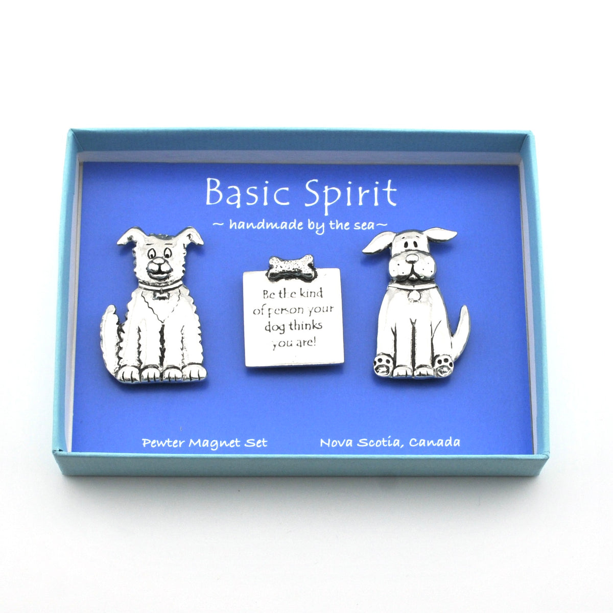 A dog-themed magnet set in a light blue presentation box with a blue insert card. The set includes two silver-toned dog magnets and a small central tag with text, labeled 'Basic Spirit' and 'handmade by the sea'.
