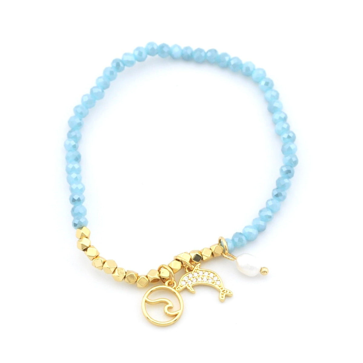 A beaded bracelet featuring light blue faceted beads, gold-tone textured spacer beads, and three charms: a gold-tone wave symbol, a gold-tone dolphin, and a small white pearl.