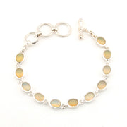 Silver bracelet with covl opal stones on a white background