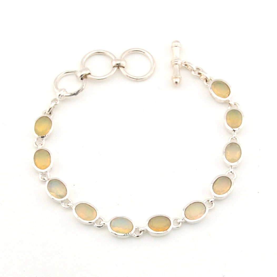 Silver bracelet with covl opal stones on a white background