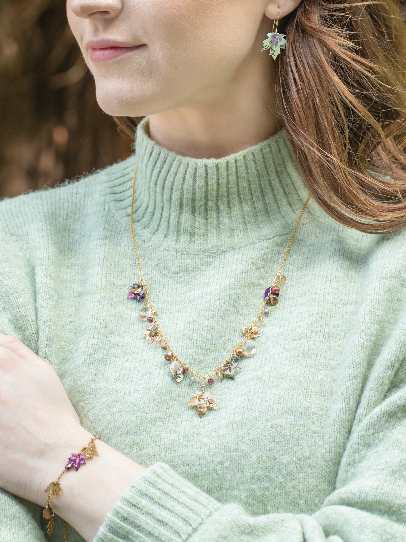 Falling Leaves Necklace on a person with mint colored sweater