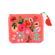 Floral embroidered pouch with a tassel on a white background