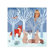 A square art print or card featuring a winter woodland scene with a red fox, two brown rabbits, a brown owl in a tree, a small bird, and pale blue leafless trees in the snow.
