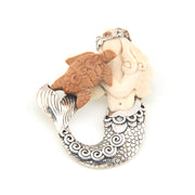 Pendant with mermaid and sea turtle design on a white background