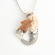 Necklace with a unique pendant featuring a mermaid with turtle on a white background