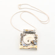 Necklace with a decorative pendant featuring a white dove and blue stones on a white background