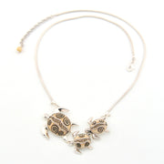 Necklace with turtle-shaped pendants on a white background
