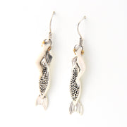 Pair of mermaid earrings with intricate designs on a white background