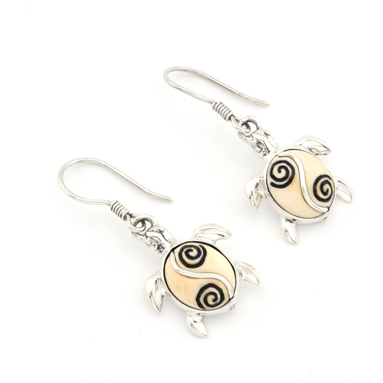 Sea turtle earrings with silver accents on a white background