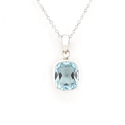 A silver pendant necklace featuring a cushion-cut light blue gemstone, displayed on a clean white background.