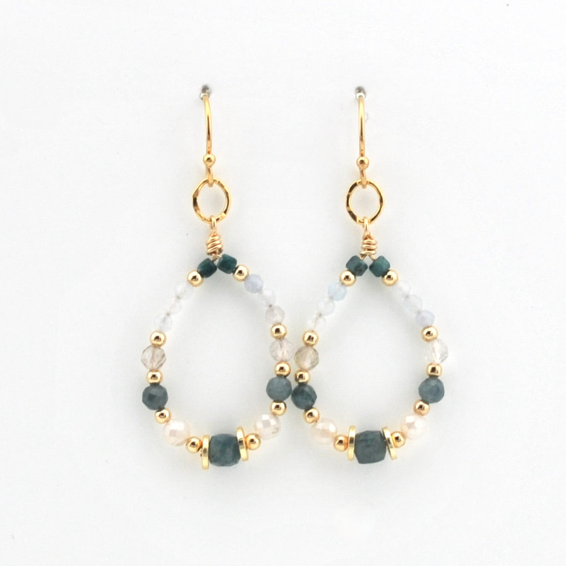 A pair of gold-tone dangle earrings with open teardrop-shaped hoops, decorated with faceted dark green beads, small white pearls, and clear glass beads on a white background.