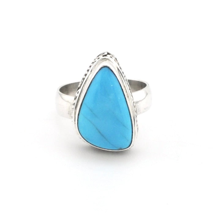 Turquoise triangular ring with silver on white background.