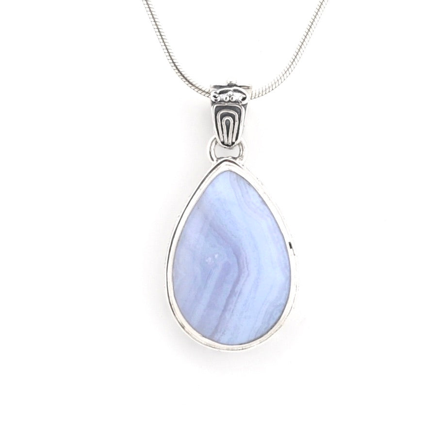 A silver teardrop pendant necklace featuring a light blue marbled stone, suspended from a silver snake chain against a plain white background.