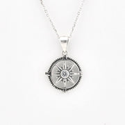 A silver compass pendant necklace on a delicate silver chain, displayed against a clean white background.