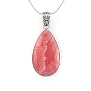 A teardrop-shaped pink gemstone pendant in a silver bezel setting on a silver chain, shown against a plain white background.