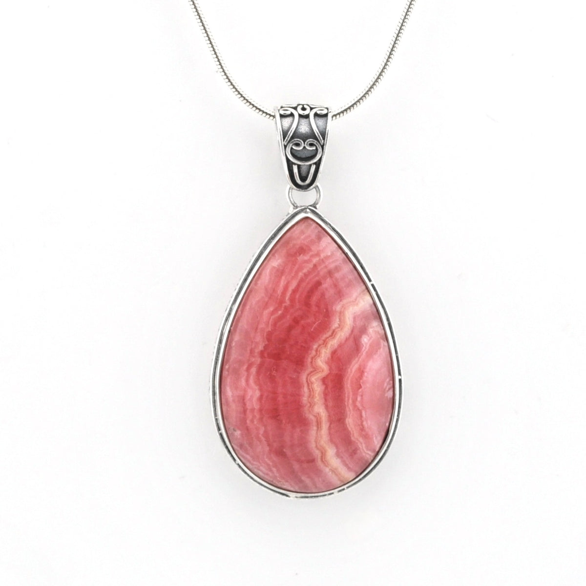 A teardrop-shaped pendant necklace featuring a pink and red banded stone in a silver bezel setting, suspended from a silver chain against a plain white background.