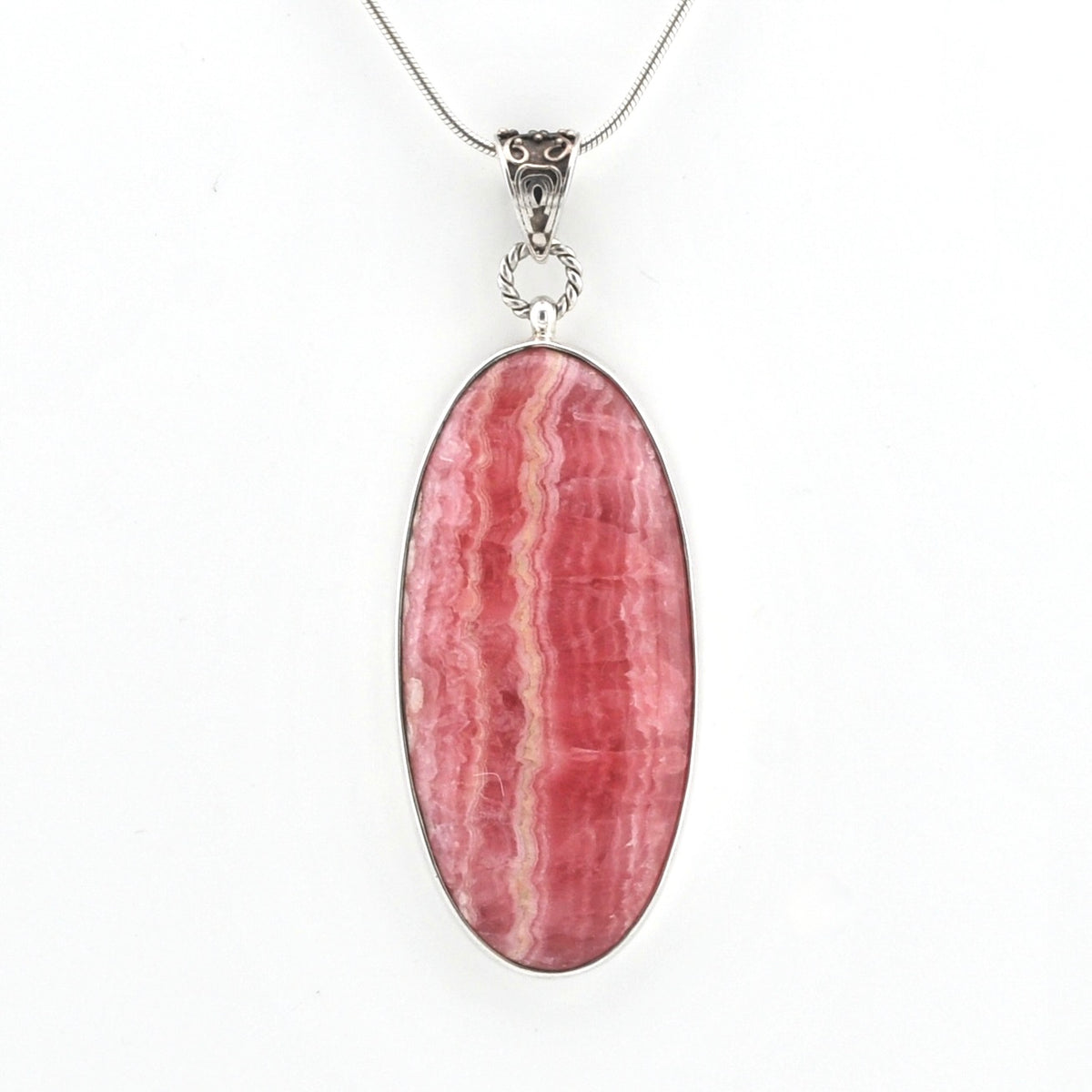 An oval pendant necklace featuring a pink and red striped mineral stone, set in a silver-toned bezel with a silver chain, shown against a plain white background.