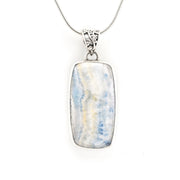 A silver rectangular pendant necklace featuring a marbled blue, white, and pale yellow stone, suspended from a delicate silver chain against a plain white background.