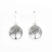 A pair of silver tree of life dangle earrings with circular pendants, shown against a plain white background.