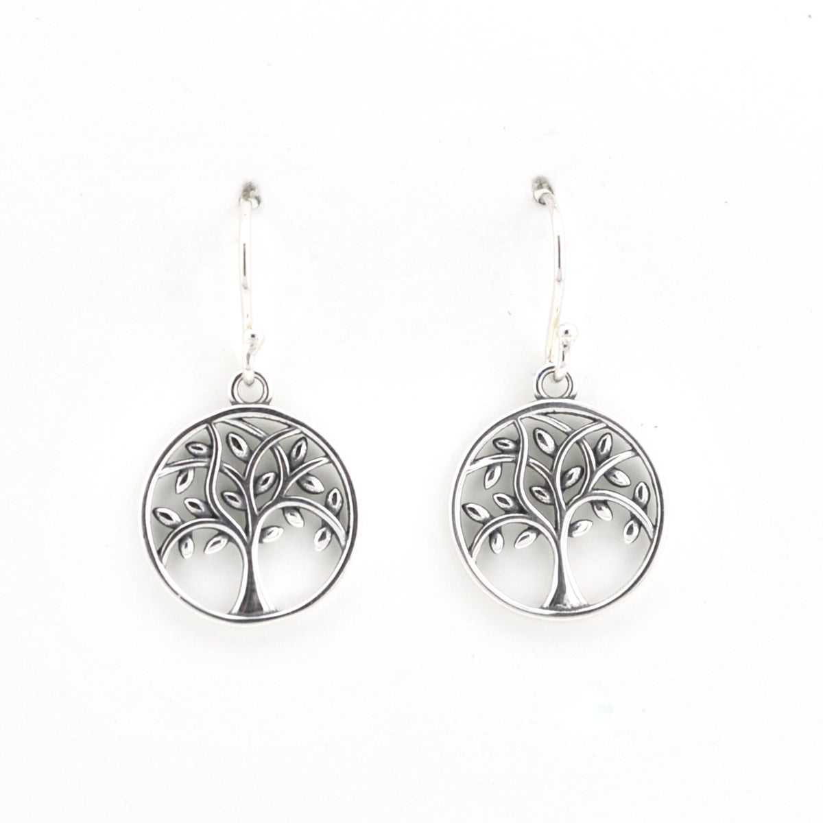 A pair of silver tree of life dangle earrings with circular pendants, shown against a plain white background.