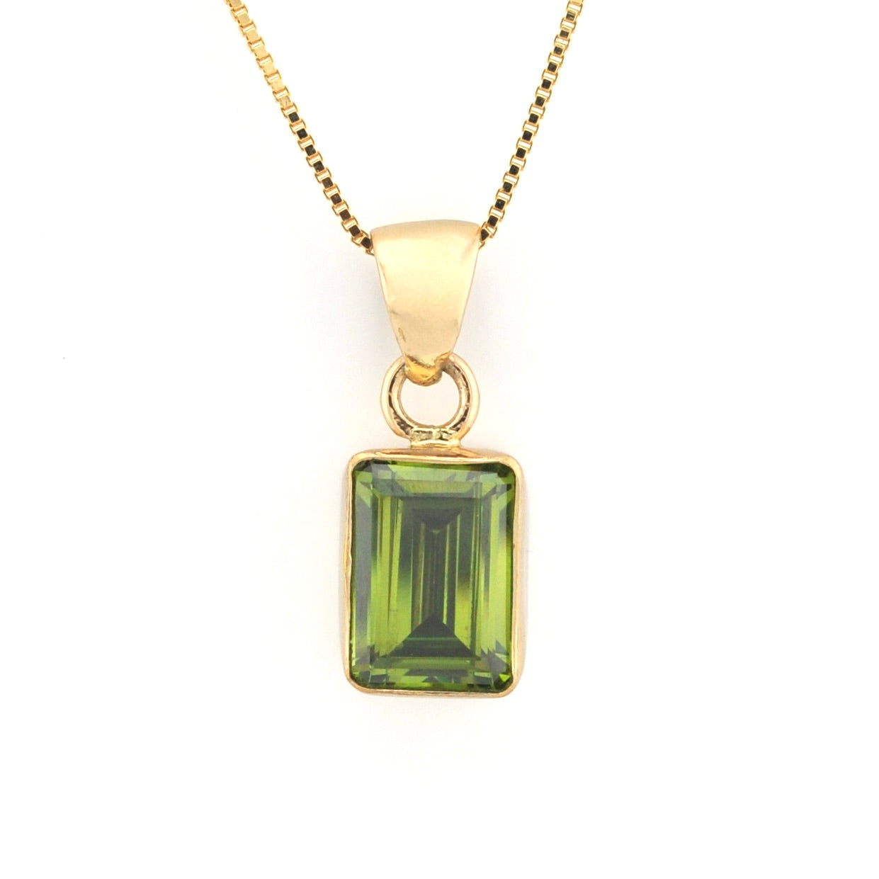 A yellow gold pendant necklace featuring a rectangular emerald-cut green gemstone, suspended from a matching gold chain against a plain white background.