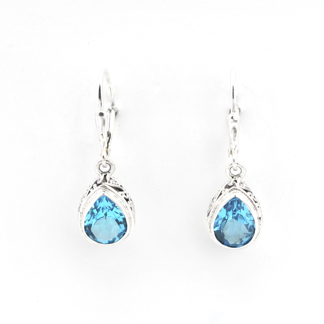 Pair of silver earrings with blue teardrop-shaped gemstones on a white background