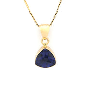 Trillion shaped tanzanite pendant on white background.