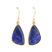 Gold earrings with blue stone drops on a white background