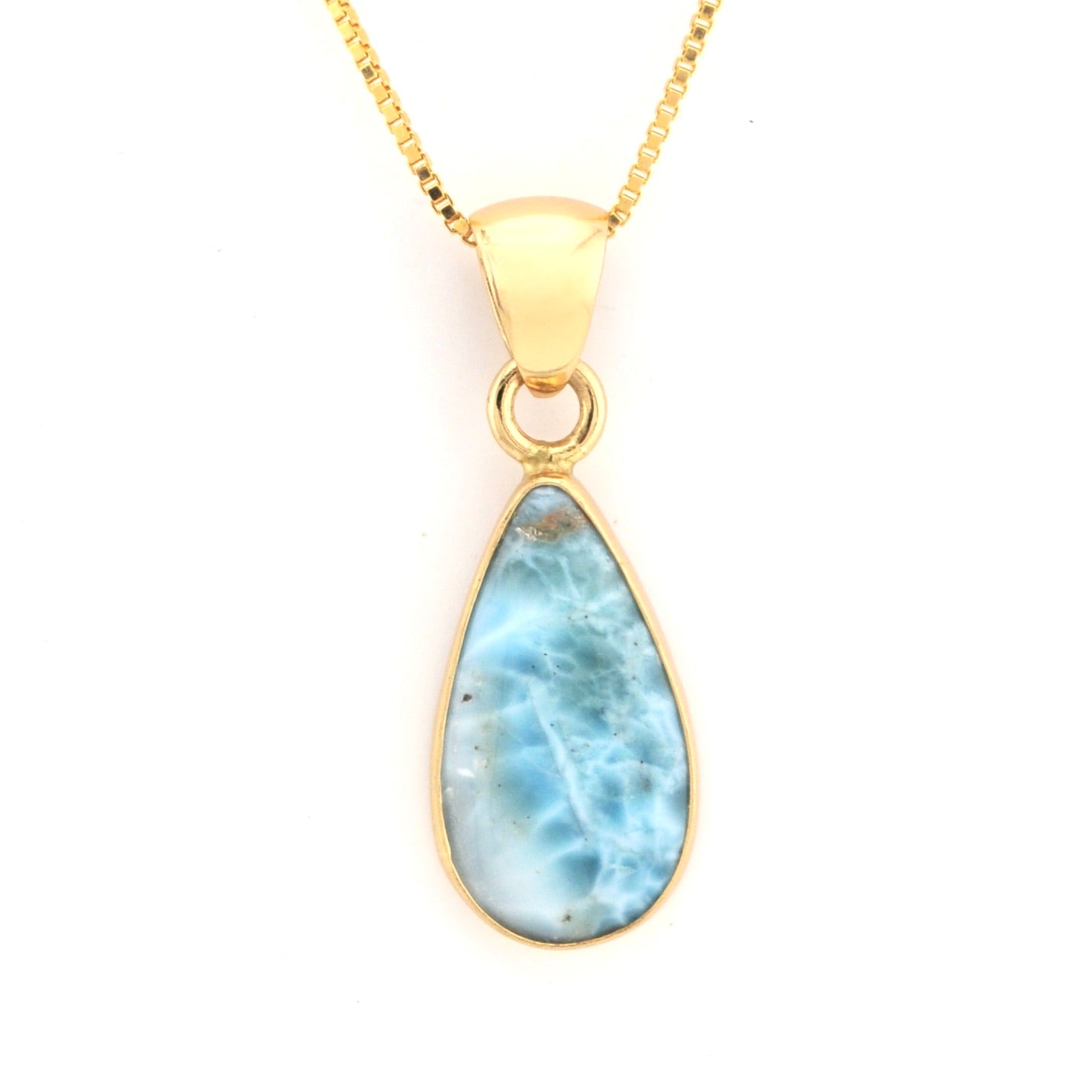 Gold necklace with a teardrop-shaped larimar pendant on a white background