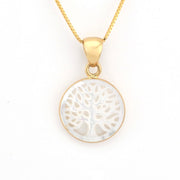 Gold necklace with a white tree-of-life pendant on a white background