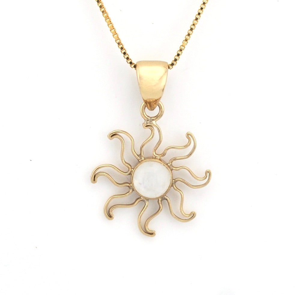 Gold sun-shaped pendant necklace on a white background