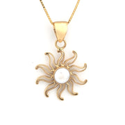 Gold sun-shaped pendant with a pearl center on a white background