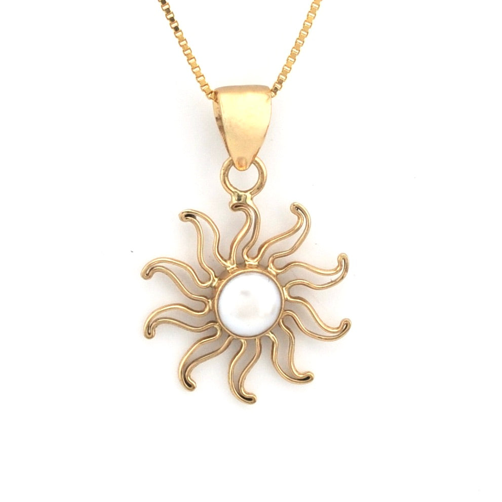 Gold sun-shaped pendant with a pearl center on a white background