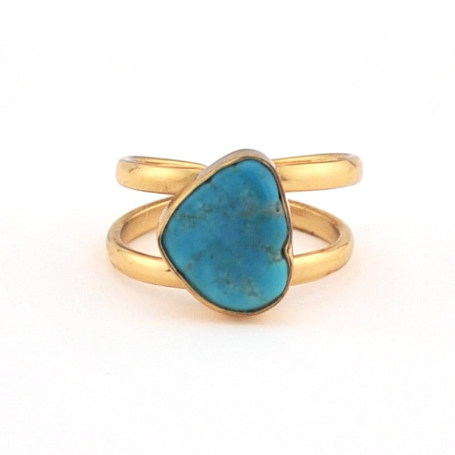 Gold ring with a blue stone on a white background