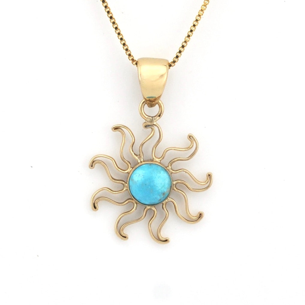 Gold sun-shaped pendant with a blue center on a white background