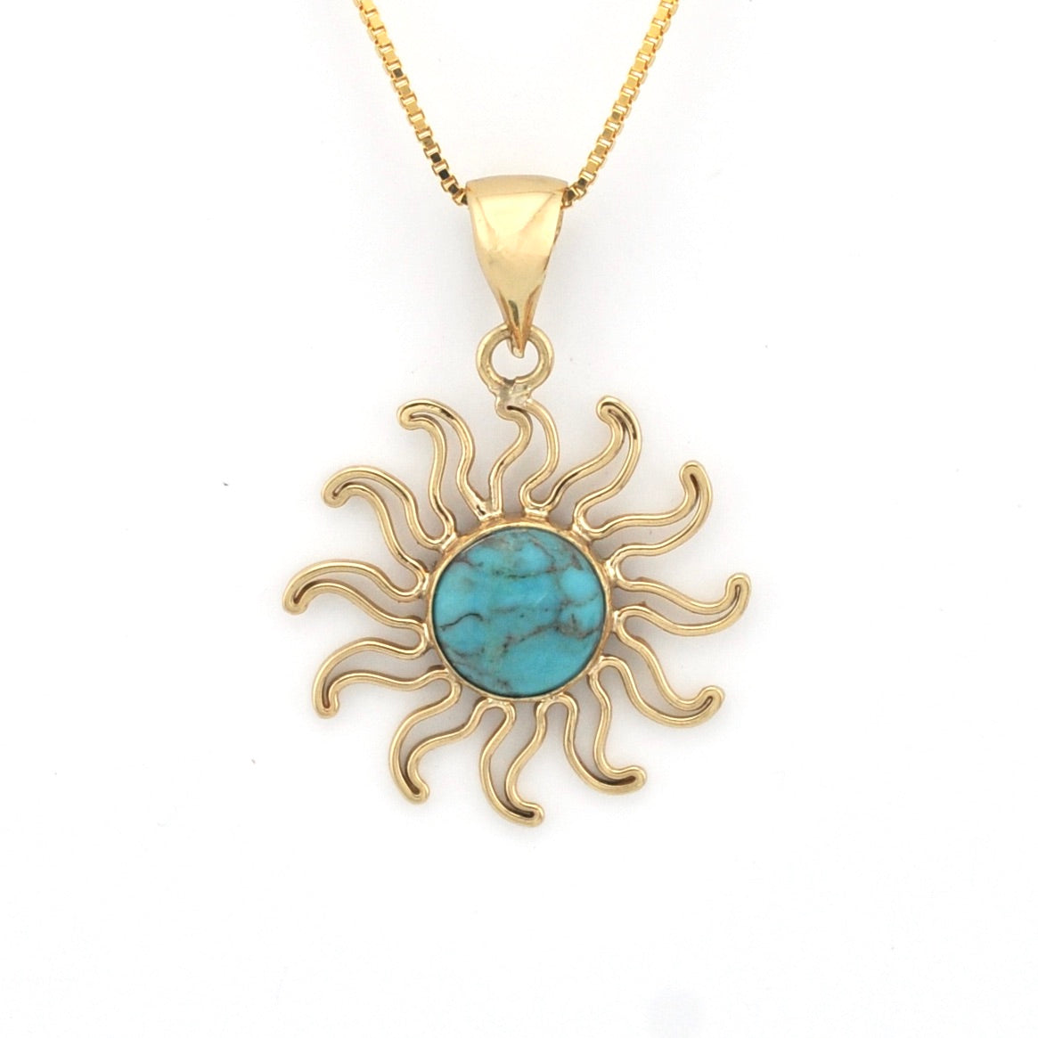 Gold sun-shaped pendant with turquoise center on a white background