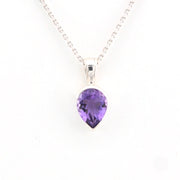 Purple teardrop pendant on a silver chain against a white background
