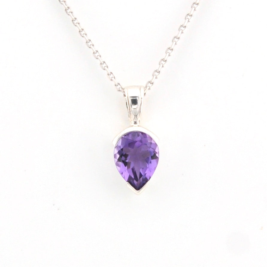 Purple teardrop pendant on a silver chain against a white background