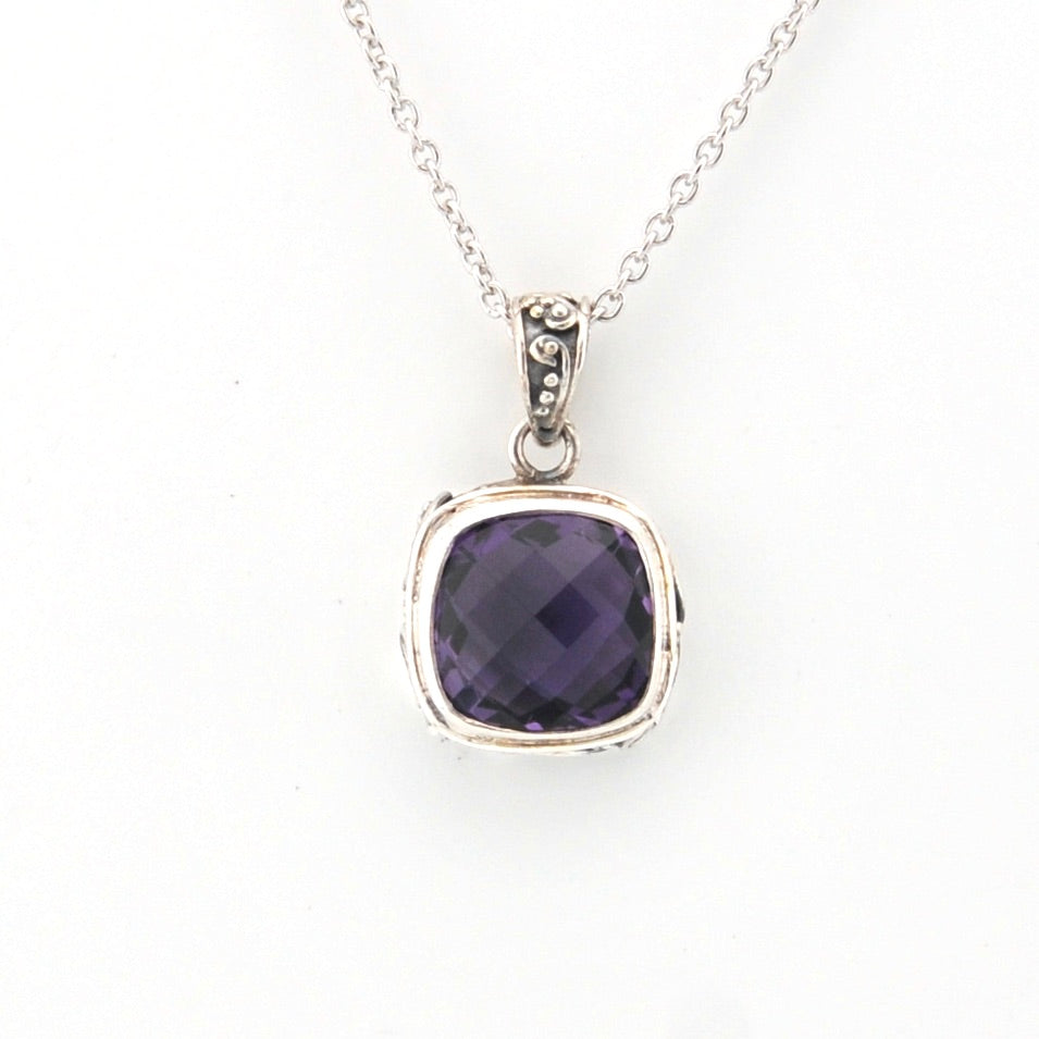 Silver necklace with a purple gemstone pendant on a white background