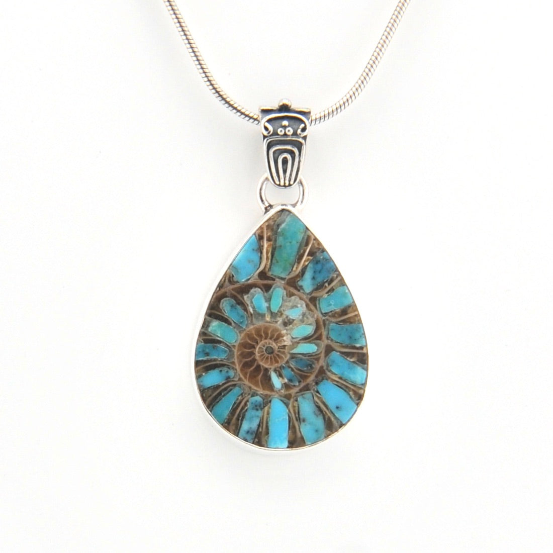 Teardrop-shaped pendant with blue and bronze design on a white background
