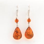 Pair of amber teardrop earrings on a white background