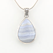Teardrop-shaped pendant with blue and white pattern on a white background