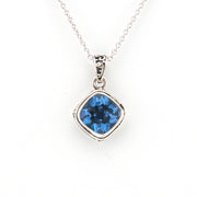 Silver necklace with a blue gemstone pendant on a white background
