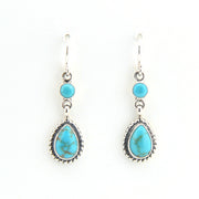 Turquoise teardrop earrings with silver hooks on a white background