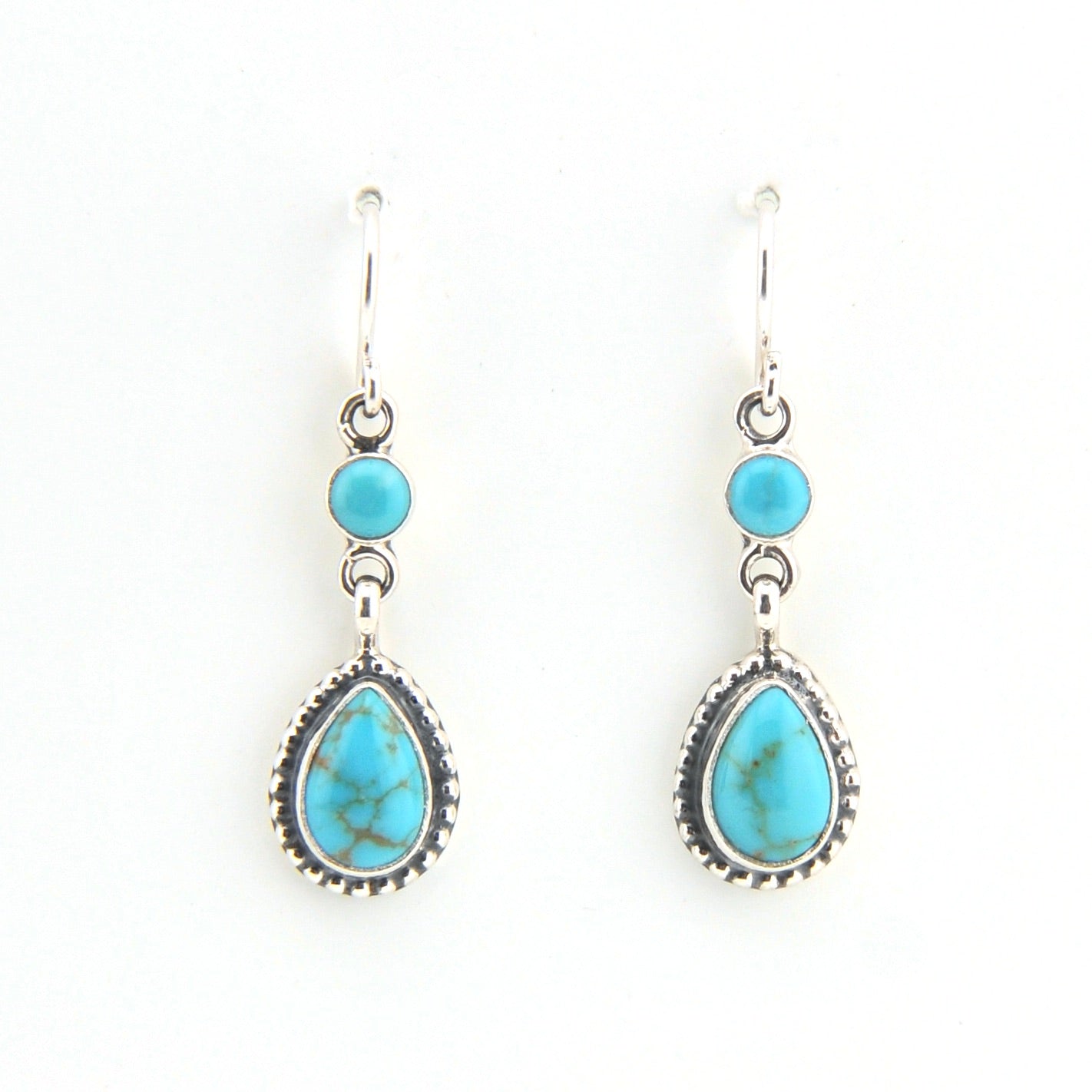 Turquoise teardrop earrings with silver hooks on a white background