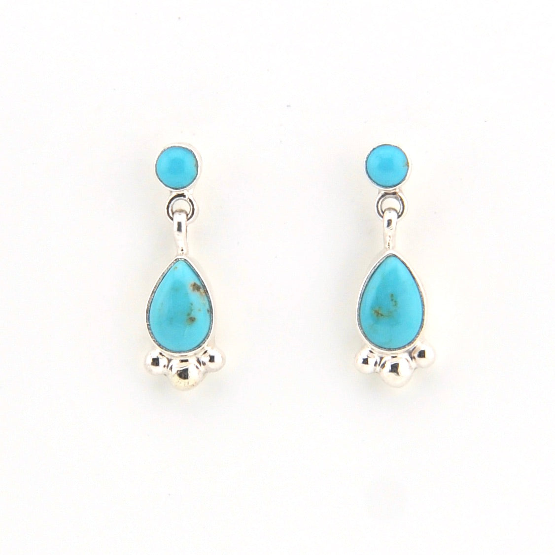 Turquoise teardrop earrings on a white background