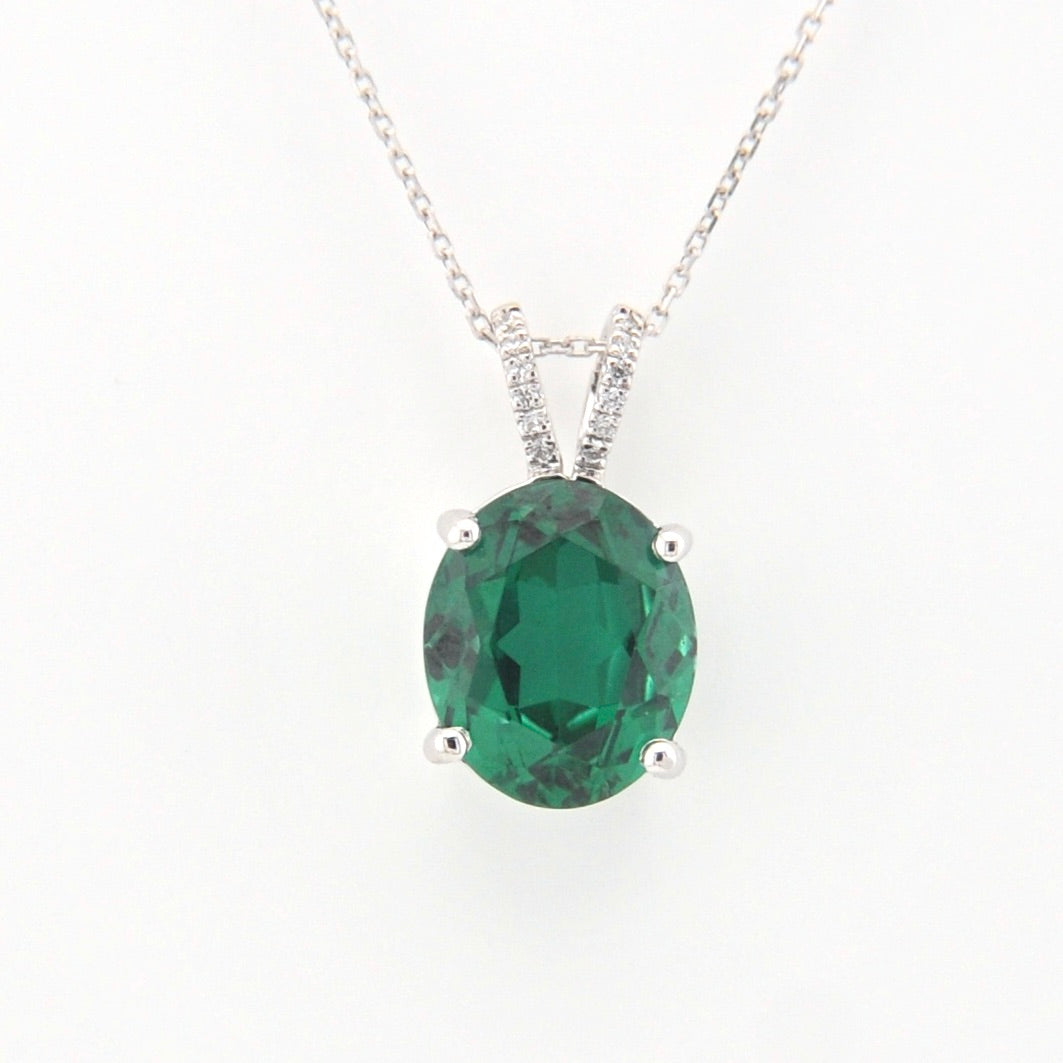 Green gemstone pendant on a white background