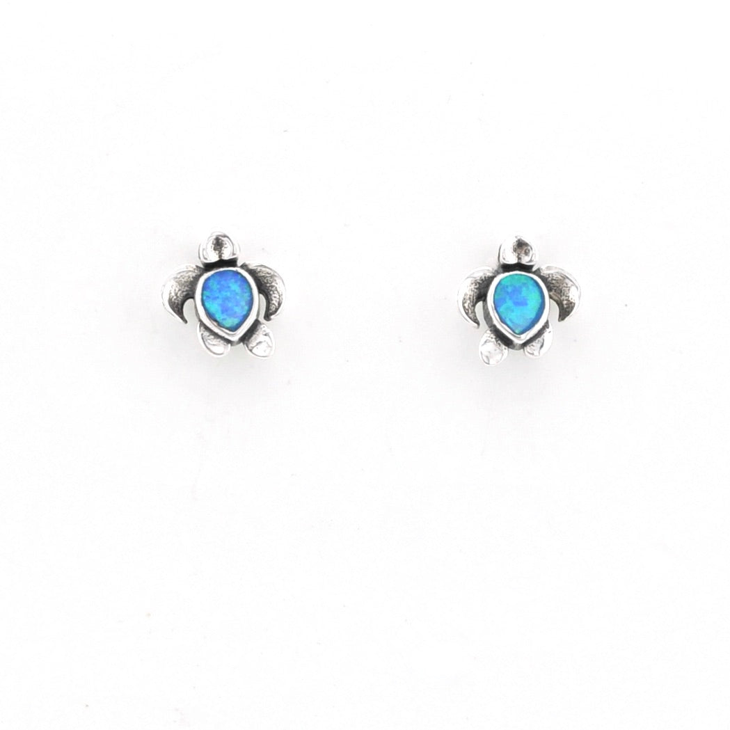 Turtle-shaped earrings with blue gemstones on a white background